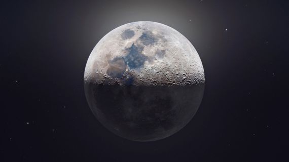 the moon coming up over the dark clouds