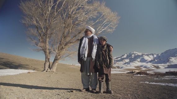 Man and boy in front of tree
