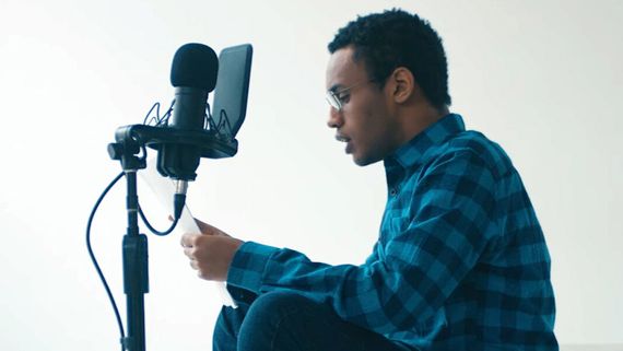 a man sitting in front of a microphone