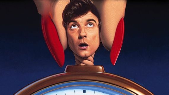 Griffin Dunne's head being held by two fingers