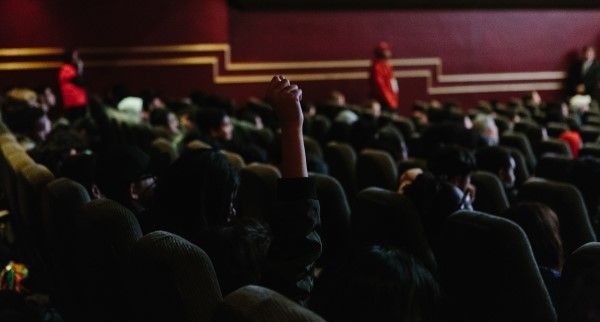 a hand raised from an audience