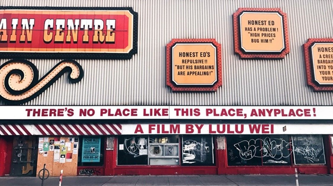 Honest ed's storefront with "theres no place like this place" sign