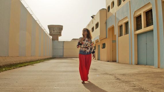 Woman walking in sunny courtyard