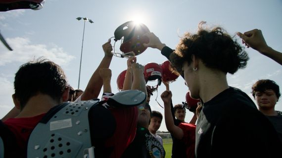 a football team with their arms up