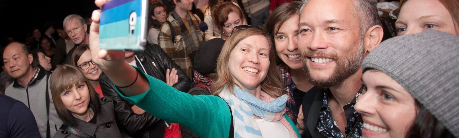 Audience members taking a selfie with a special guest