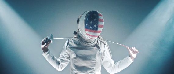 someone in fencing equipment with the american flag on their mask
