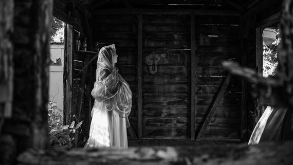 Woman with veil in wooden building