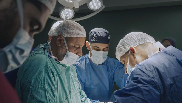 Four doctors operating
