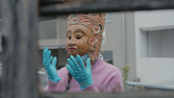 Person in clay mask