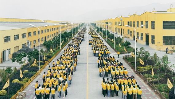rows of people in yellow and white shirts on a road