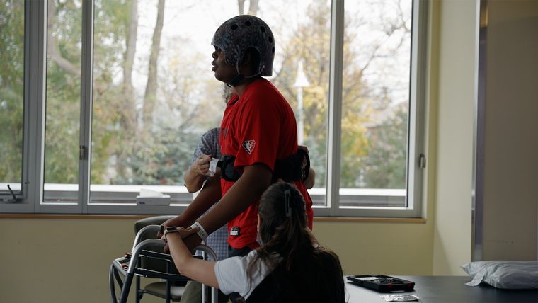 Youth with helmet and walker in a hospital
