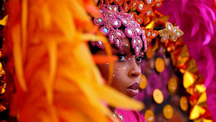 A woman wearing a Caribbean carnival headdress
