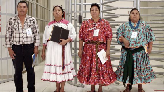 four people wearing badges