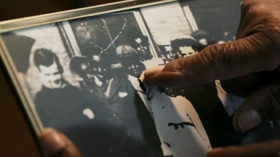 someone holding an old black and white photo