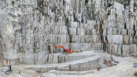 a excavator among a backdrop of carved rock