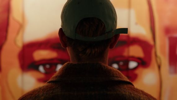 Person looking at mural of eyes