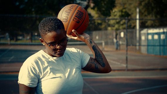 someone holding a basketball on a court