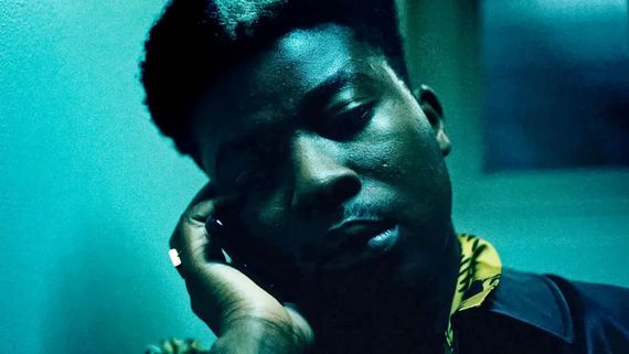 a close up of someone with their head in their hand