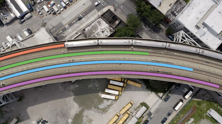 a top view of a city with train lines highlighted in colours