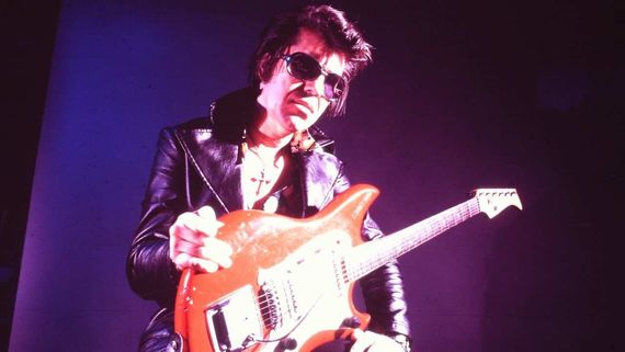 a man with sunglasses and a guitar