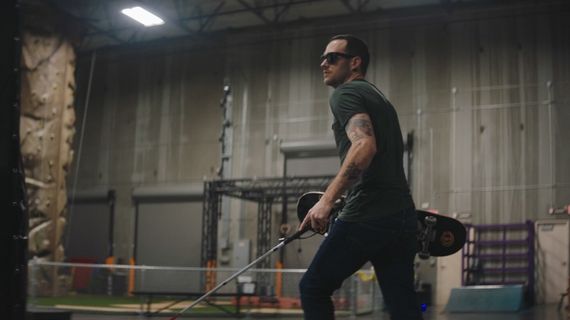 a blind man walking with a walking stick