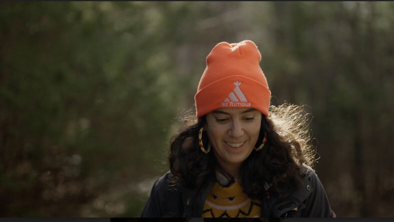 a smiling young woman in the forest