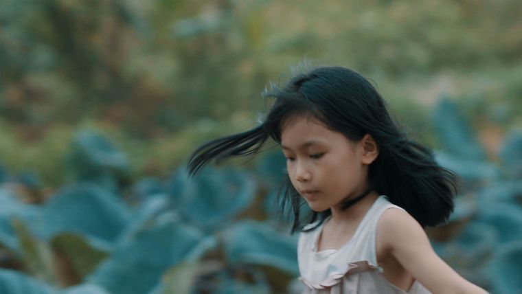 a little girl walking outside