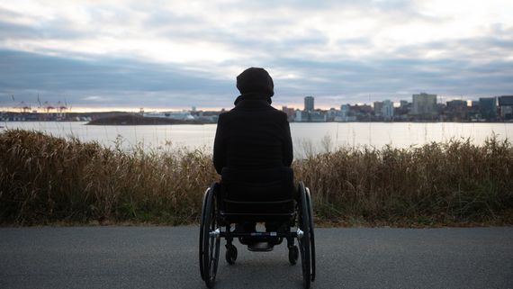 Woman in wheelchair looking out at lake