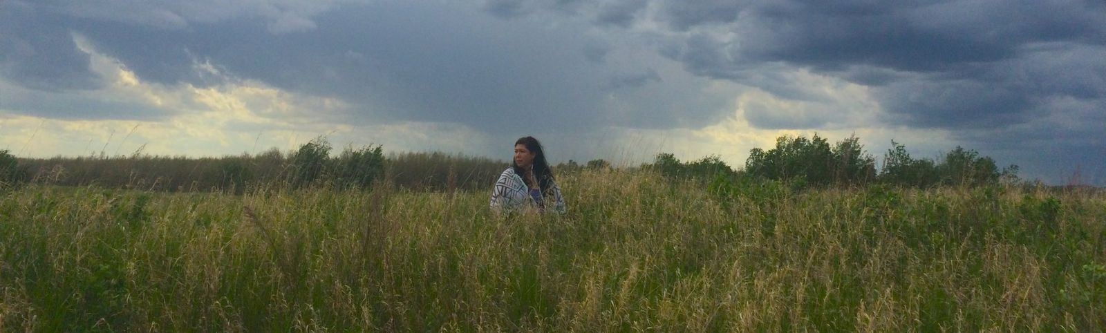 Indigenous woman standing in a field