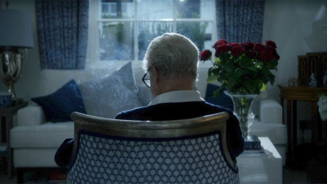 the back of an older man in a chair