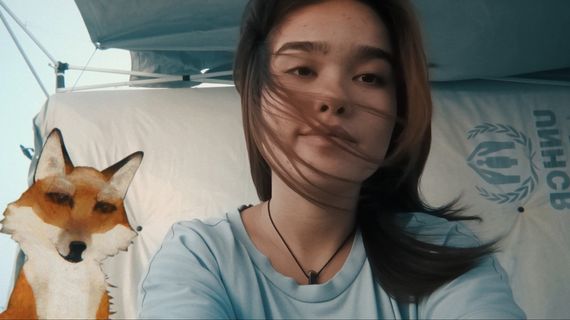 Girl sitting beside animated fox