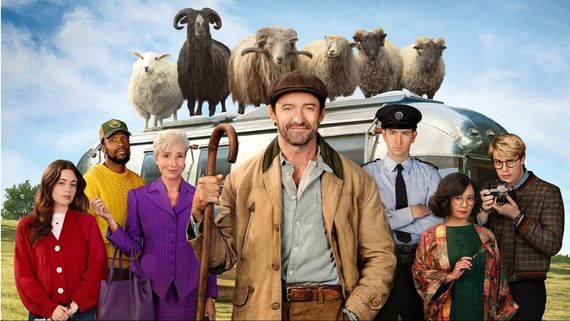 Hugh Jackman and a group of people with sheep