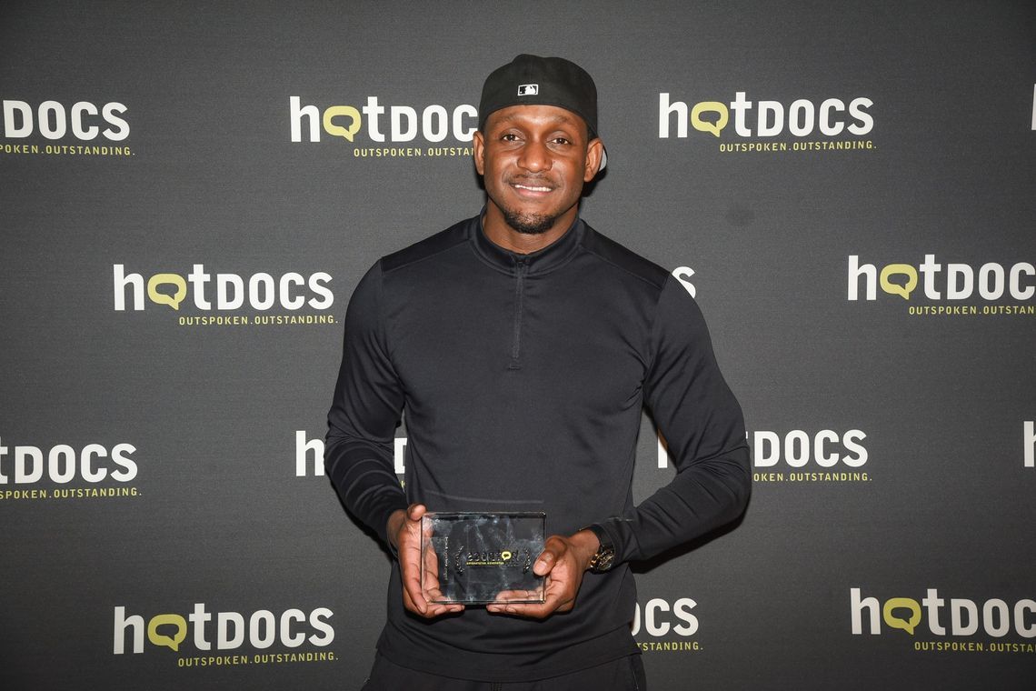 Director Rico King holding Hot Docs award