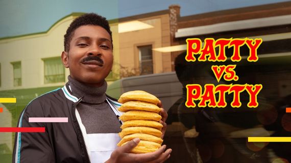 a man standing with a stack of pattys