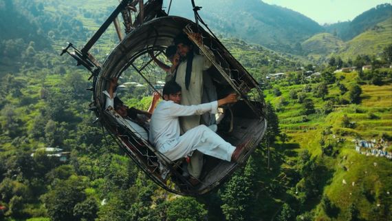 People inside a cable car hanging crookedly